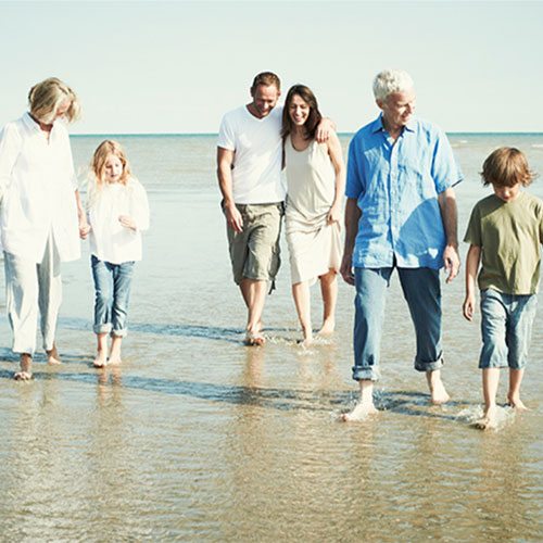 Three generations of people walking in the sun